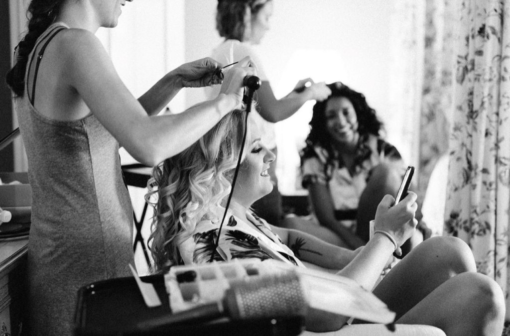 two women getting their hair done and laughing